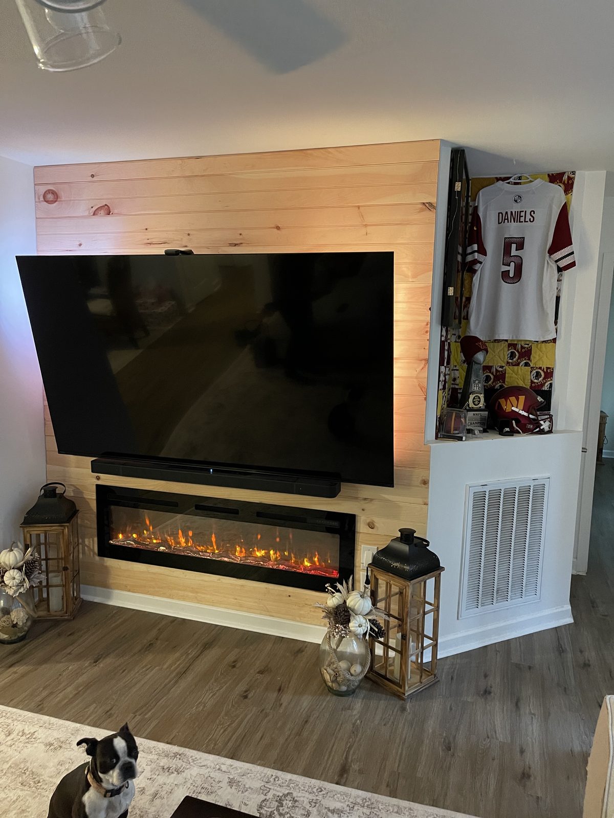 Pine accent wall + fireplace + TV mount (finished).