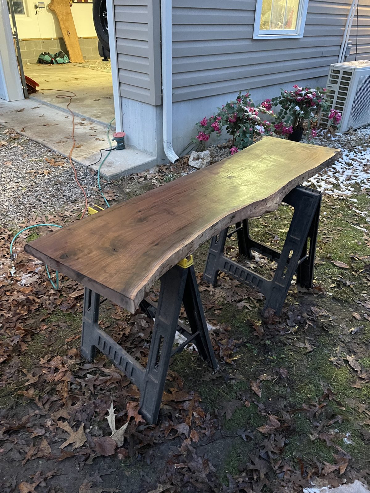 Live-edge slab finishing (stain/seal work).